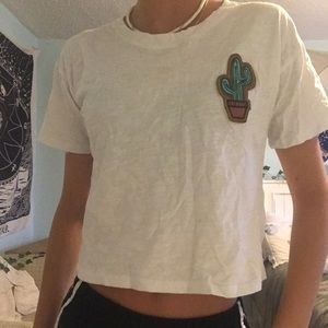 Short sleeve tee with felt cactus in the corner